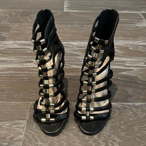 Black leather Vince Camuto strap bootie with gold detailing